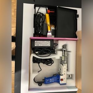 Rug tufting gun with carpet trimmer.